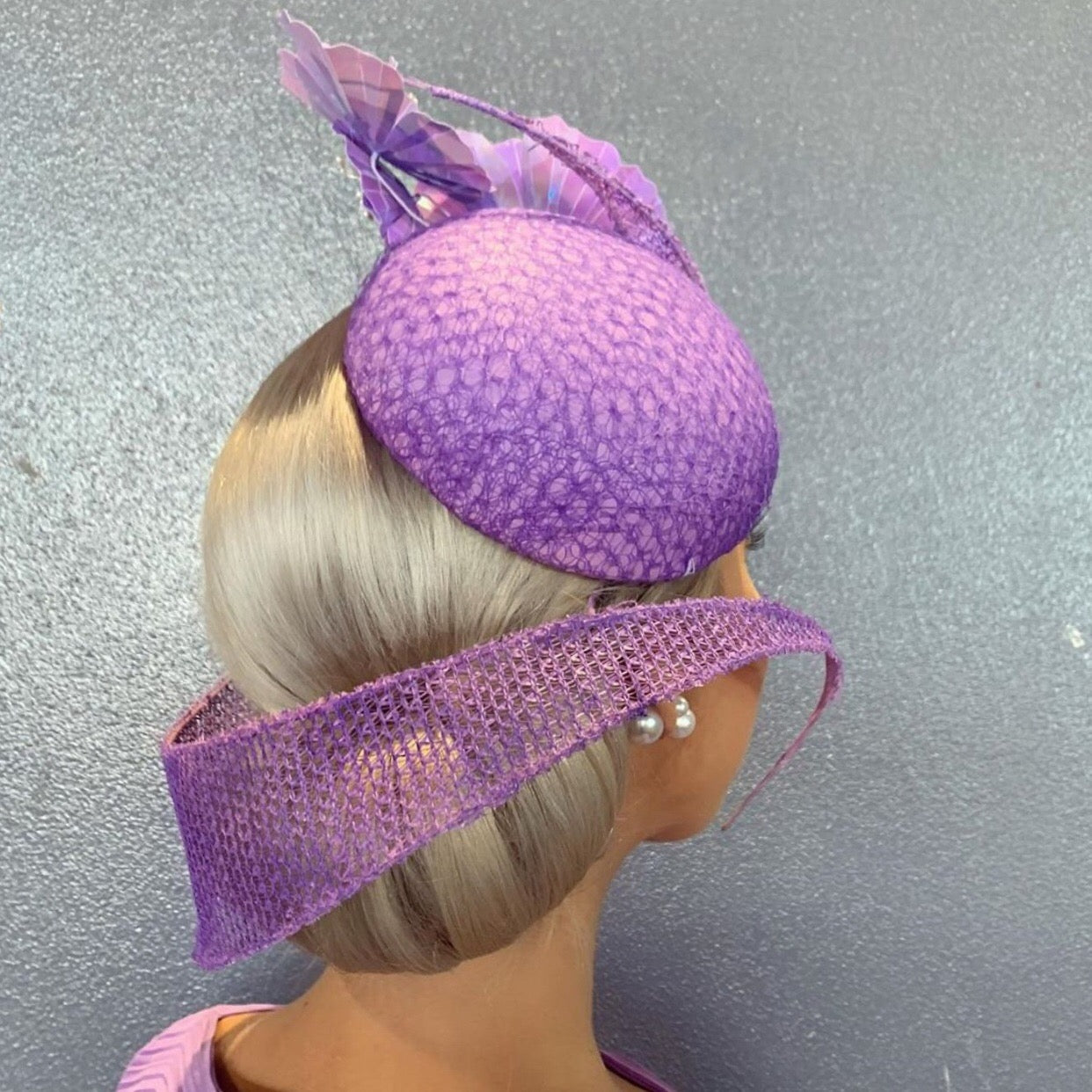 Lavender Purple swirl designer hat on a woman with blonde hair