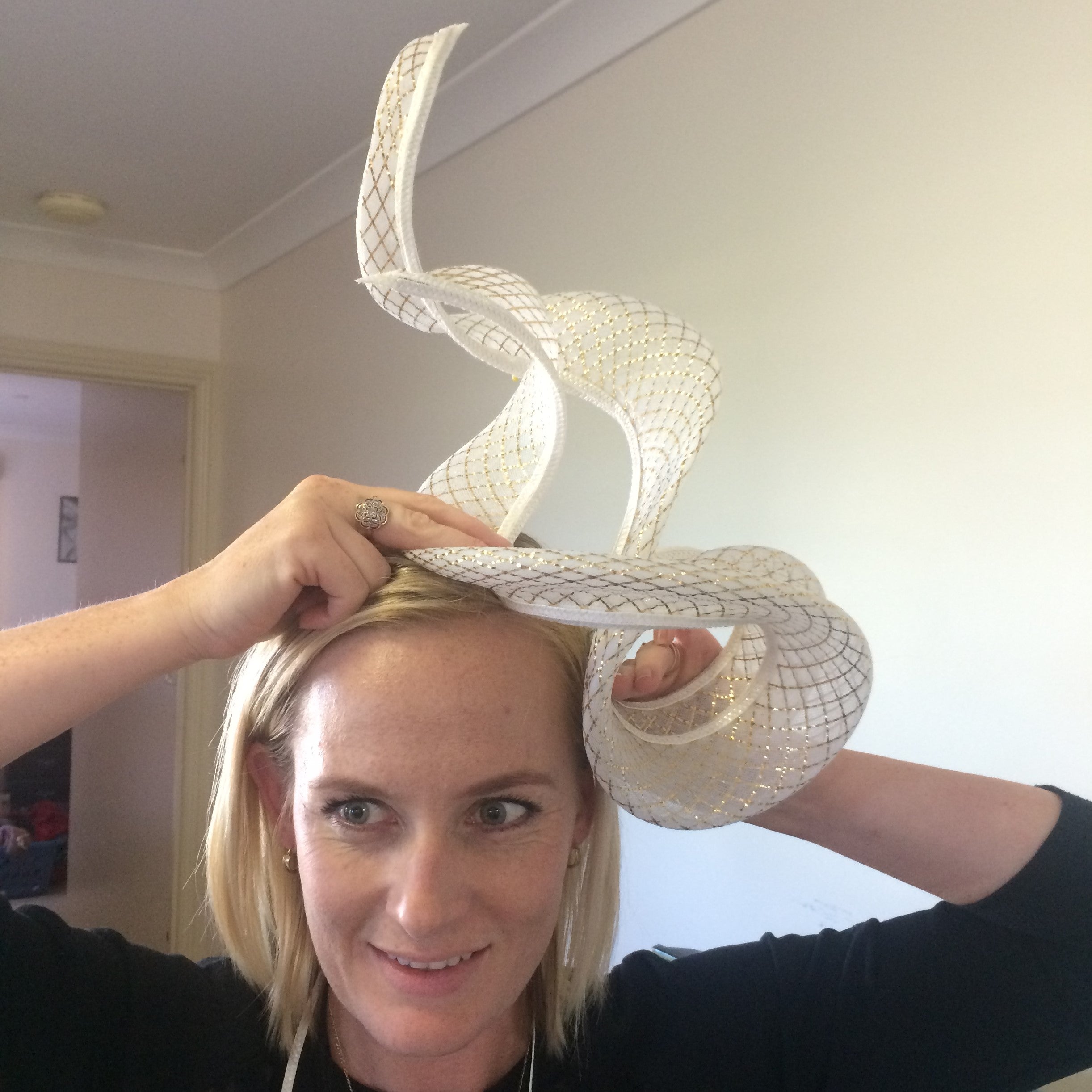 White Swirl Hat being tried on and fitted