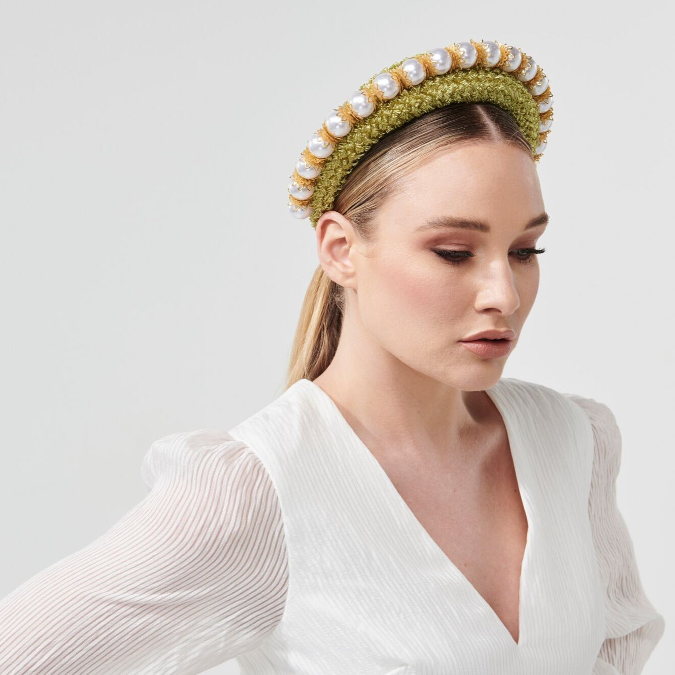 Headband style headpiece with an overlay of vintage straw cloth and adornment of uniformed glossy pearl beads. Colour: Cool avocado Attachment: Headband Sizing: one size fits most Spring racing carnival Millinery by Rebecca Share. Dress in the latest designer hats and headpieces to complete your Fashions on the Field outfit. Beautiful headbands, wide brim, fascinators and bridal collection. Melbourne Cup, Derby races hat.
