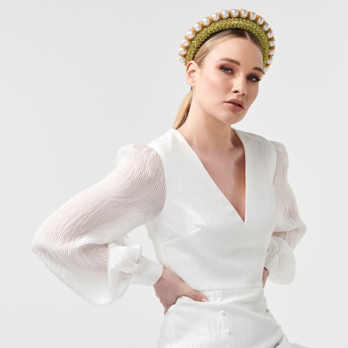 Headband style headpiece with an overlay of vintage straw cloth and adornment of uniformed glossy pearl beads. Colour: Cool avocado Attachment: Headband Sizing: one size fits most Spring racing carnival Millinery by Rebecca Share. Dress in the latest designer hats and headpieces to complete your Fashions on the Field outfit. Beautiful headbands, wide brim, fascinators and bridal collection. Melbourne Cup, Derby races hat.
