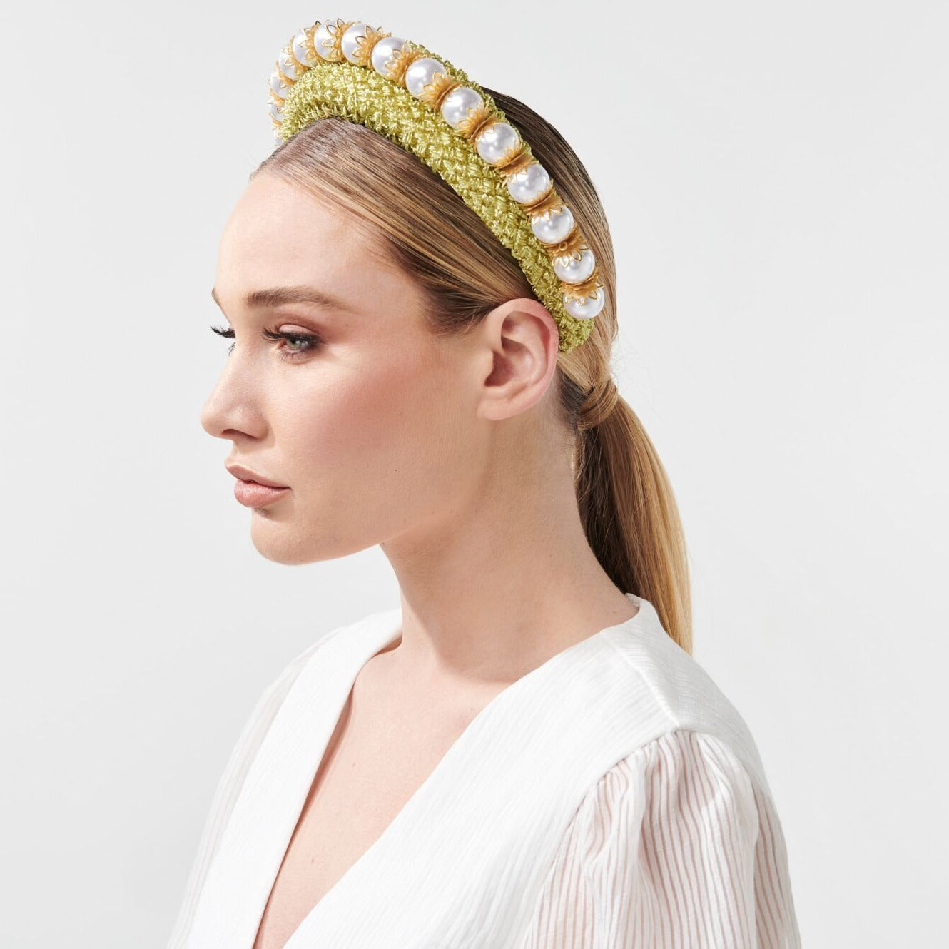 Headband style headpiece with an overlay of vintage straw cloth and adornment of uniformed glossy pearl beads. Colour: Cool avocado Attachment: Headband Sizing: one size fits most Spring racing carnival Millinery by Rebecca Share. Dress in the latest designer hats and headpieces to complete your Fashions on the Field outfit. Beautiful headbands, wide brim, fascinators and bridal collection. Melbourne Cup, Derby races hat.