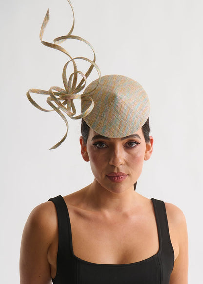 Woman wearing a black dress and decorative hat with a white background