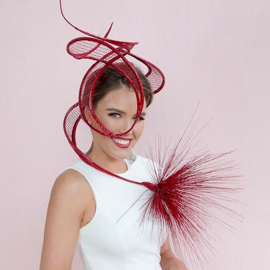 Girl with brown hair wearing Fashions on the Field award winning millinery headwear creation.