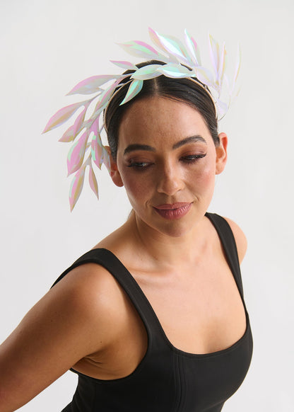 Woman wearing a leaf headpiece and black dress with a white background